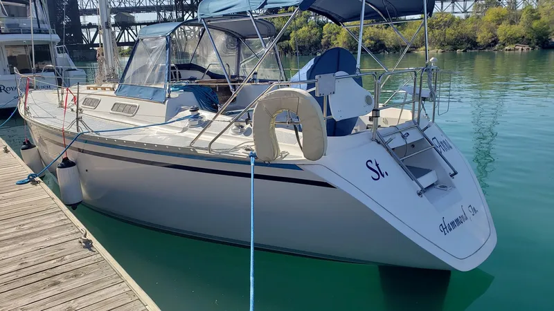 Slide: The Image of 1989 Hunter Legend 37 sailboat docked in marina, featuring sleek design and spacious deck. - 5