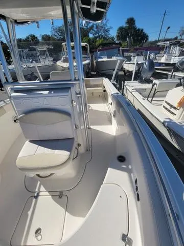 Slide: The Image of 2016 Robalo R222 boat interior with seating and console, docked at marina. - 10