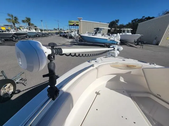 Slide: The Image of 2016 Robalo R222 boat with trolling motor in a marina setting. - 11
