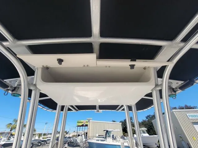 Slide: The Image of 2016 Robalo R222 boat T-top storage compartment under sunny sky. - 14