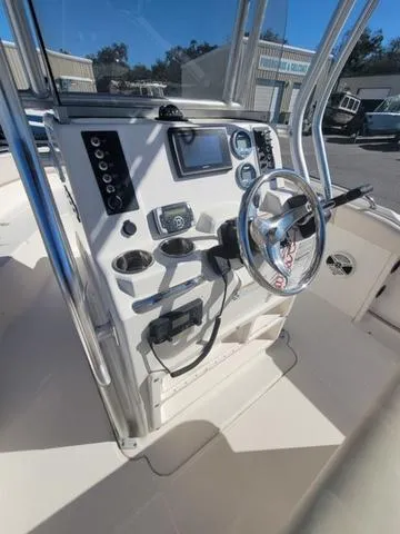 Slide: The Image of 2016 Robalo R222 boat console with steering wheel and navigation controls. - 15