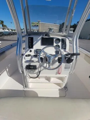 Slide: The Image of 2016 Robalo R222 boat console with steering wheel and navigation controls. - 17
