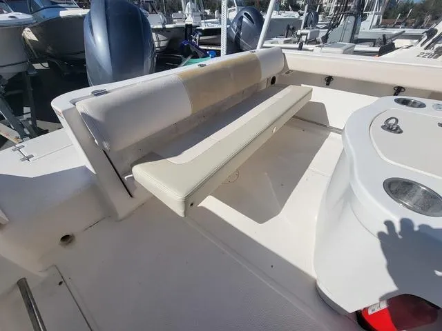 Slide: The Image of 2016 Robalo R222 boat interior with seating and storage compartments. - 18
