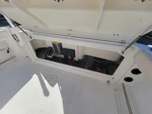 Slide: The Image of 2016 Robalo R222 boat storage compartment with open hatch, showcasing interior equipment. - 22