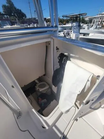Slide: The Image of 2016 Robalo R222 boat interior with compact marine toilet. - 24