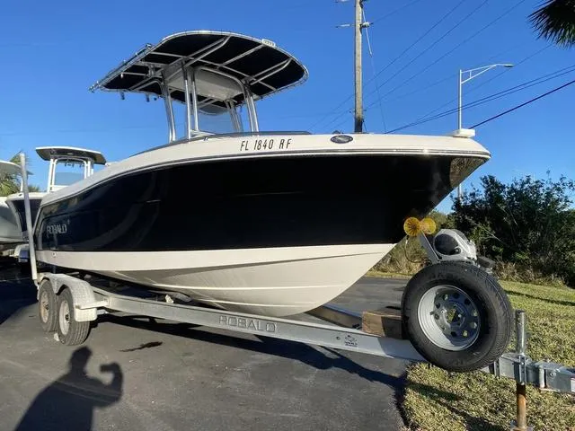Slide: The Image of 2016 Robalo R222 boat on trailer under clear blue sky. - 29