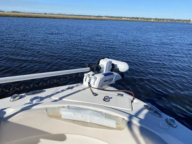 Slide: The Image of 2016 Robalo R222 boat with Minn Kota trolling motor on calm water. - 31