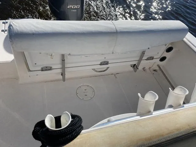 Slide: The Image of 2016 Robalo R222 boat interior with covered seating and rod holders. - 33