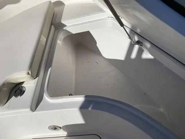 Slide: The Image of Storage compartment on a 2016 Robalo R222 boat, open with visible seating. - 35