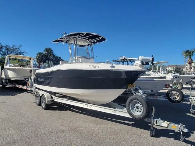 Slide: The Image of 2016 Robalo R222 boat on trailer under clear blue sky. - 4