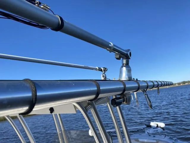 Slide: The Image of Robalo R222 2016 boat with fishing rod holders against a clear blue sky. - 41