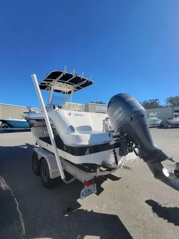 Slide: The Image of 2016 Robalo R222 boat on trailer with Yamaha outboard motor in sunny marina. - 6