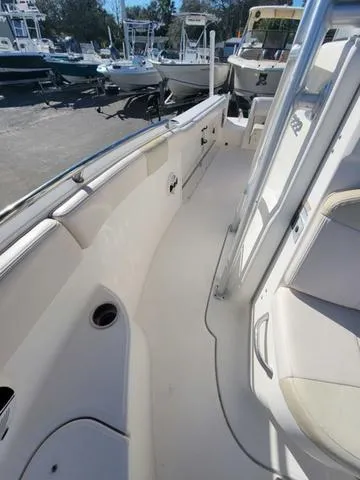 Slide: The Image of 2016 Robalo R222 boat interior with seating and storage, docked at marina. - 9