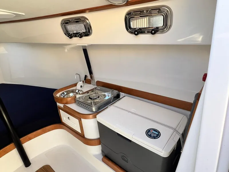 Slide: The Image of 2025 Tartan Fantail interior with compact kitchen, sink, and storage. - 15