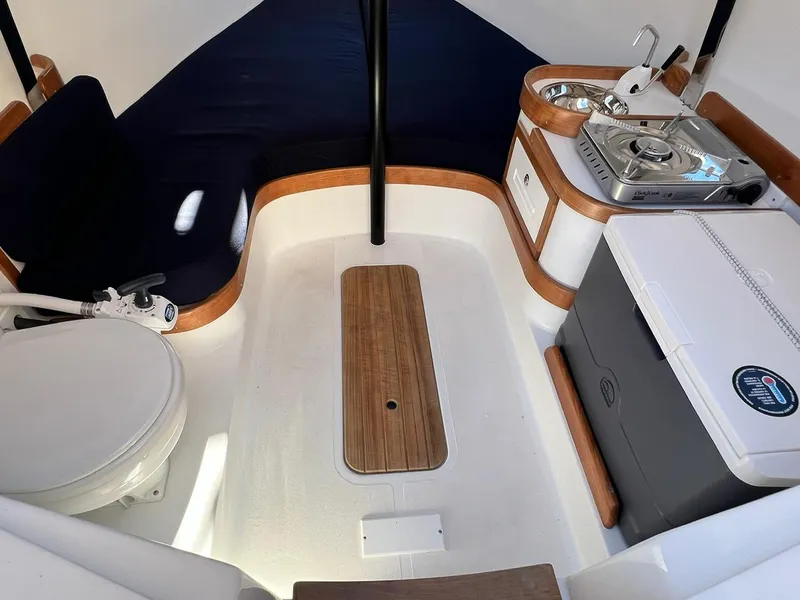 Slide: The Image of 2025 Tartan Fantail interior with compact kitchen, seating, and toilet. - 16