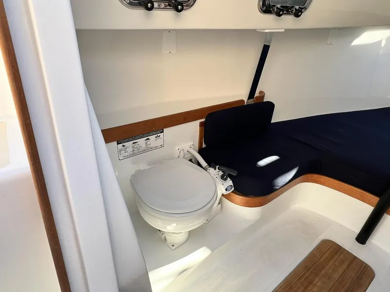 Slide: The Image of 2025 Tartan Fantail interior with compact marine toilet and seating area. - 18
