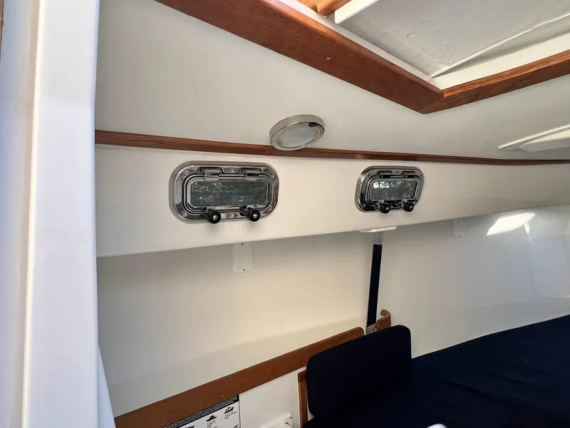 Slide: The Image of Interior of 2025 Tartan Fantail sailboat with portholes and wooden trim. - 19