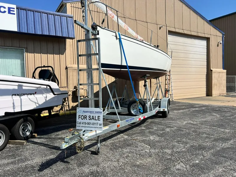 Slide: The Image of 2025 Tartan Fantail sailboat on trailer for sale outside a warehouse. - 5