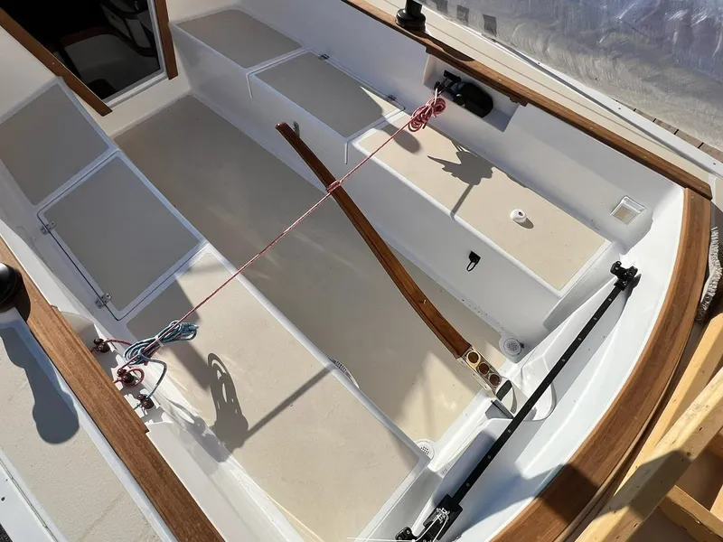 Slide: The Image of 2025 Tartan Fantail boat interior with wooden trim and seating compartments. - 7