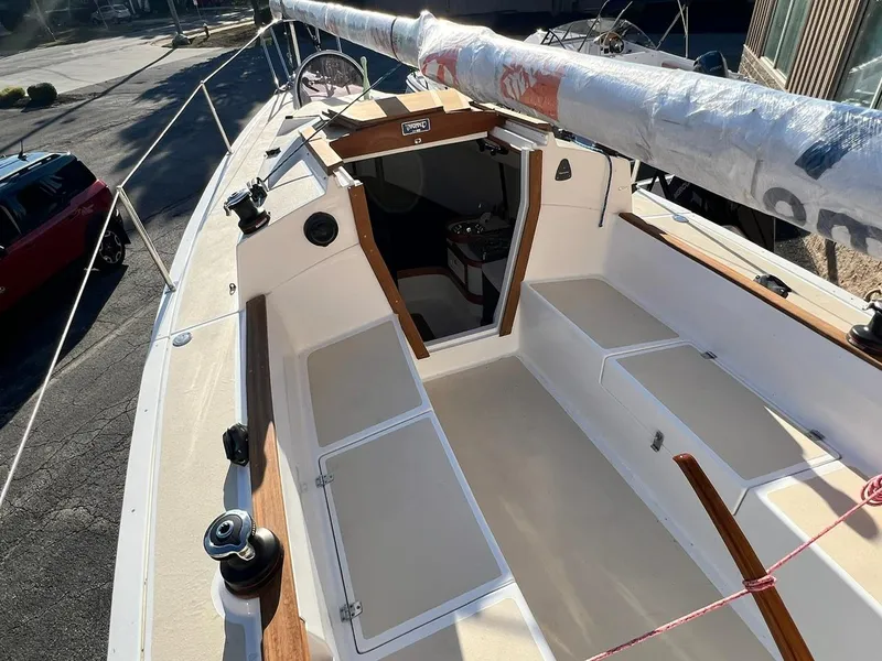 Slide: The Image of 2025 Tartan Fantail sailboat cockpit with open hatches and wrapped mast, docked in sunlight. - 8