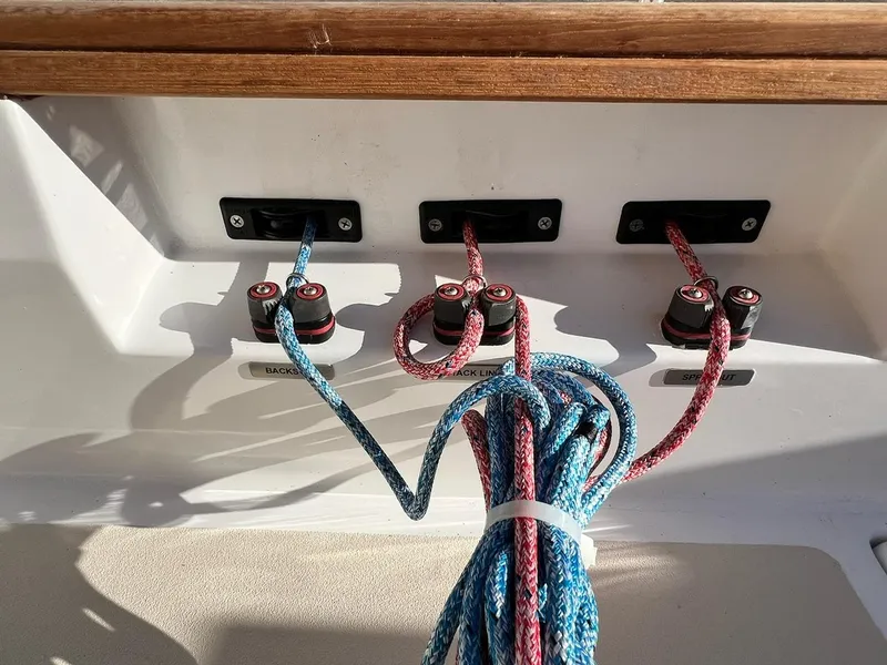 Slide: The Image of Colorful ropes and cleats on a 2025 Tartan Fantail sailboat deck. - 9