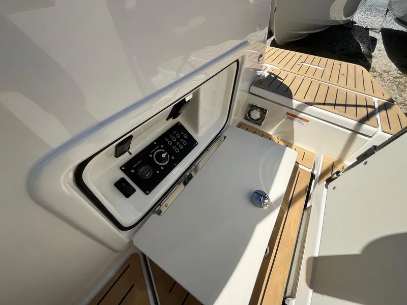 Slide: The Image of 2025 Bayliner Trophy T25 Explorer control panel on teak deck. - 11