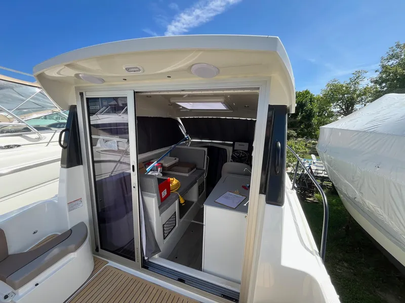 Slide: The Image of 2025 Bayliner Trophy T25 Explorer boat interior with modern amenities and sleek design. - 14