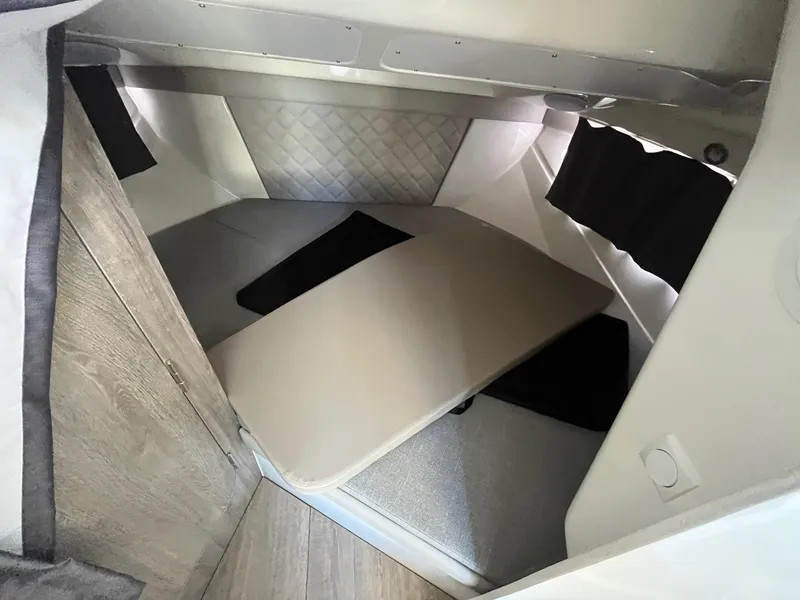 Slide: The Image of Interior cabin of 2025 Bayliner Trophy T25 Explorer, featuring a cozy seating area. - 19