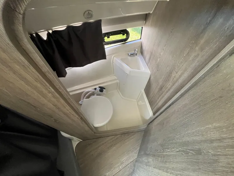 Slide: The Image of 2025 Bayliner Trophy T25 Explorer bathroom interior with compact sink and toilet. - 21
