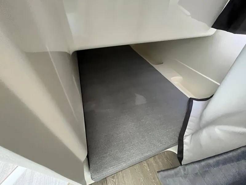 Slide: The Image of 2025 Bayliner Trophy T25 Explorer cabin interior with gray flooring. - 23