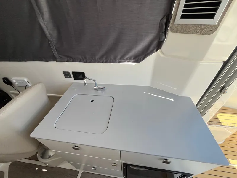 Slide: The Image of 2025 Bayliner Trophy T25 Explorer interior with compact kitchenette and modern design. - 33