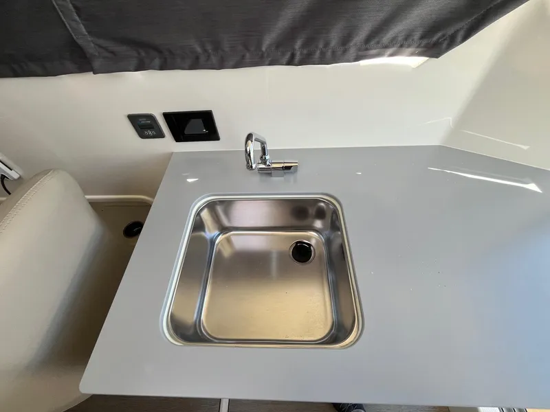 Slide: The Image of 2025 Bayliner Trophy T25 Explorer boat sink with modern faucet and countertop. - 34