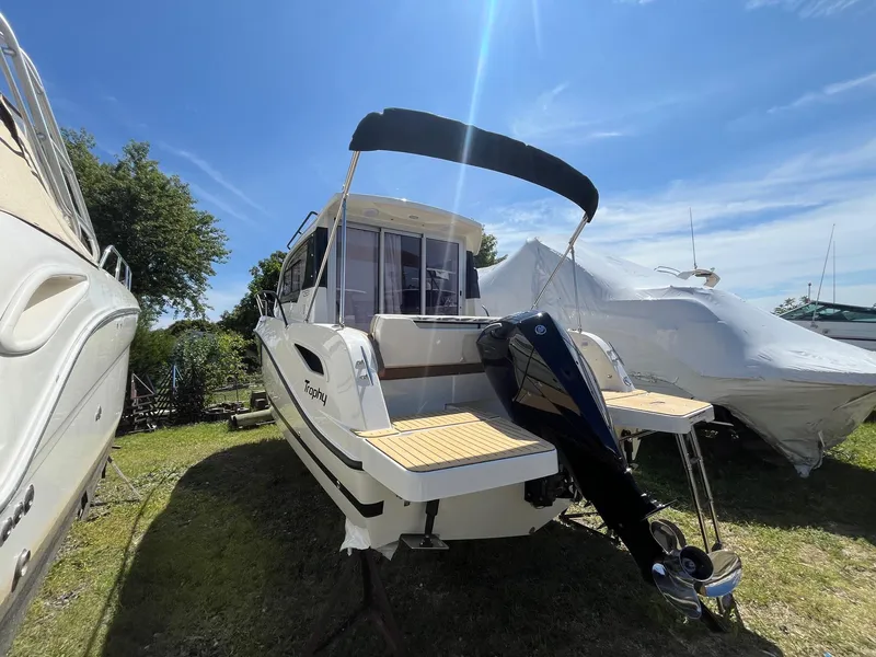 Slide: The Image of 2025 Bayliner Trophy T25 Explorer boat with outboard motor, parked outdoors. - 4