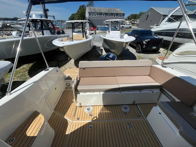 Slide: The Image of 2025 Bayliner Trophy T25 Explorer boat interior with seating and teak flooring. - 6