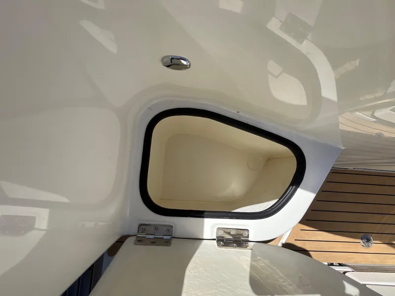 Slide: The Image of 2025 Bayliner Trophy T25 Explorer storage compartment with open hatch. - 8