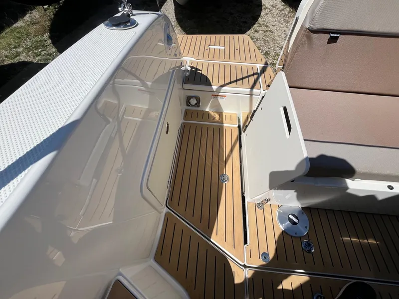 Slide: The Image of 2025 Bayliner Trophy T25 Explorer deck with seating and wood finish. - 9