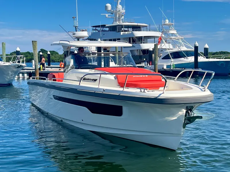 Slide: The Image of Nimbus T11 #98 TRADE! 2022 boat docked in marina with yachts in background. - 14