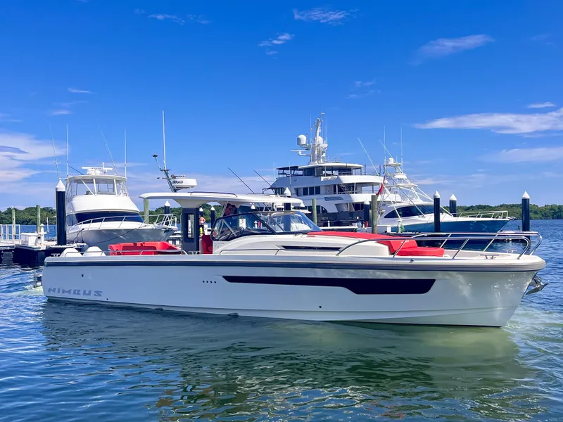 Slide: The Image of Nimbus T11 #98 TRADE! 2022 boat docked with yachts in the background. - 15