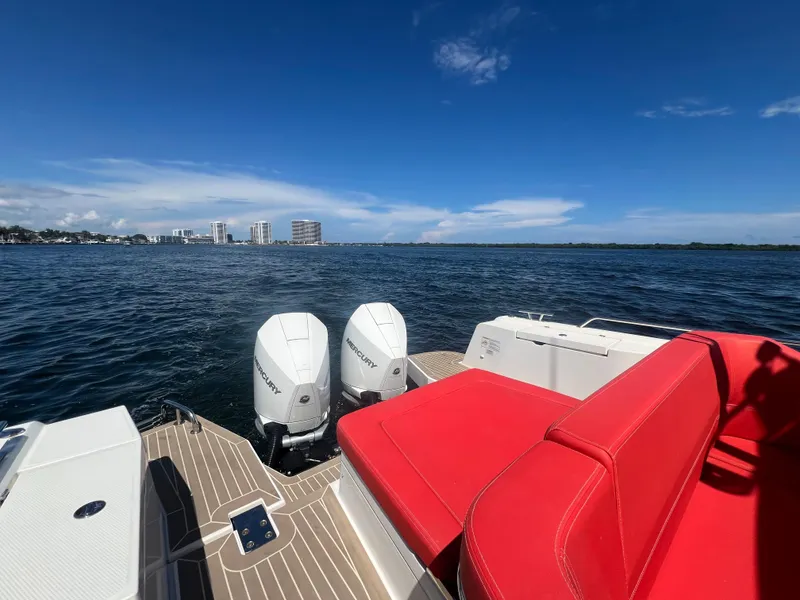 Slide: The Image of Nimbus T11 #98 TRADE! 2022 boat with red seating, dual engines, ocean view. - 16