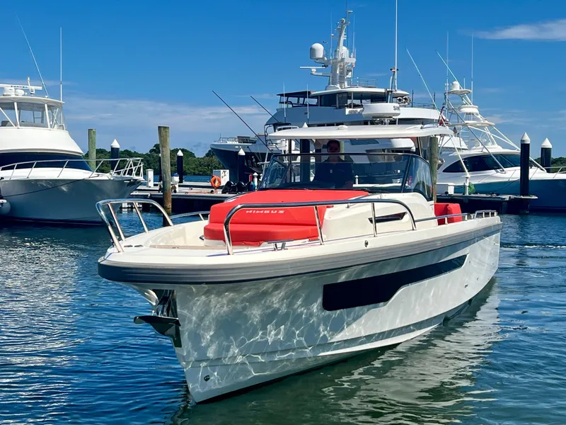 Slide: The Image of Nimbus T11 #98 TRADE! 2022 boat docked in a marina under clear blue skies. - 2