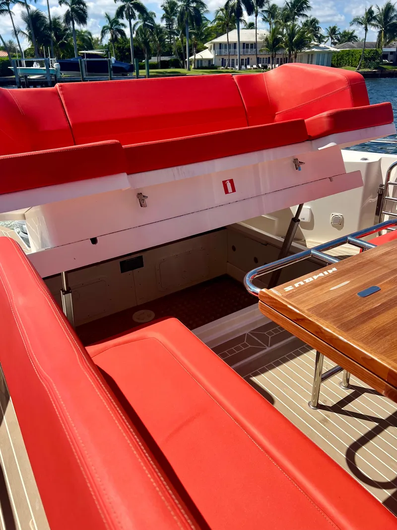 Slide: The Image of Red seating and wooden table on 2022 Nimbus T11 #98 TRADE! boat deck. - 23