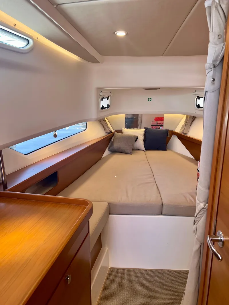 Slide: The Image of Cozy cabin interior of 2022 Nimbus T11 #98 TRADE! with comfortable bedding and wooden accents. - 25