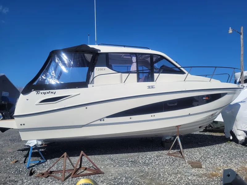 Slide: The Image of 2025 Bayliner Trophy T29 Explorer boat on display, side view, clear sky background. - 1