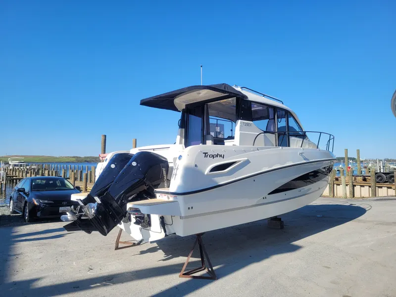 Slide: The Image of 2025 Bayliner Trophy T29 Explorer boat on display at a marina. - 11