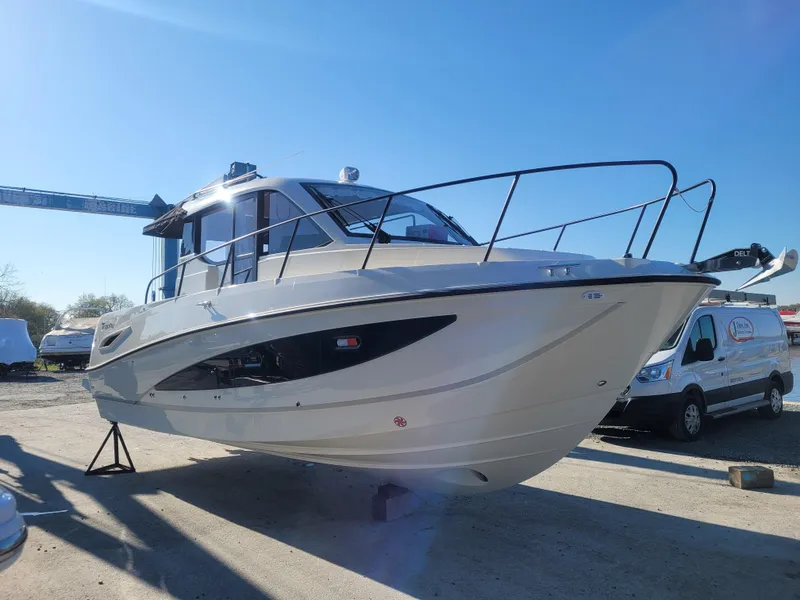 Slide: The Image of 2025 Bayliner Trophy T29 Explorer boat on display in a sunny outdoor setting. - 12