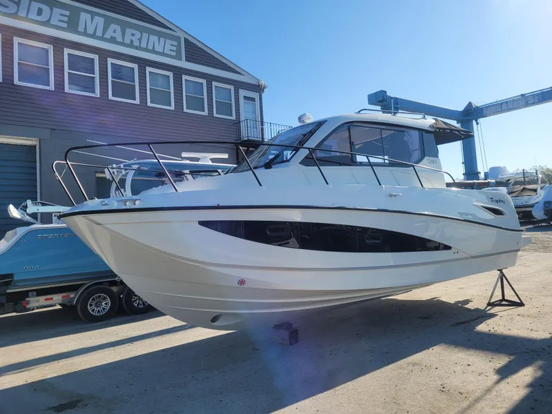 Slide: The Image of 2025 Bayliner Trophy T29 Explorer boat displayed at a marine facility. - 13