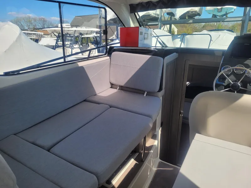 Slide: The Image of Interior of 2025 Bayliner Trophy T29 Explorer with modern seating and steering area. - 6