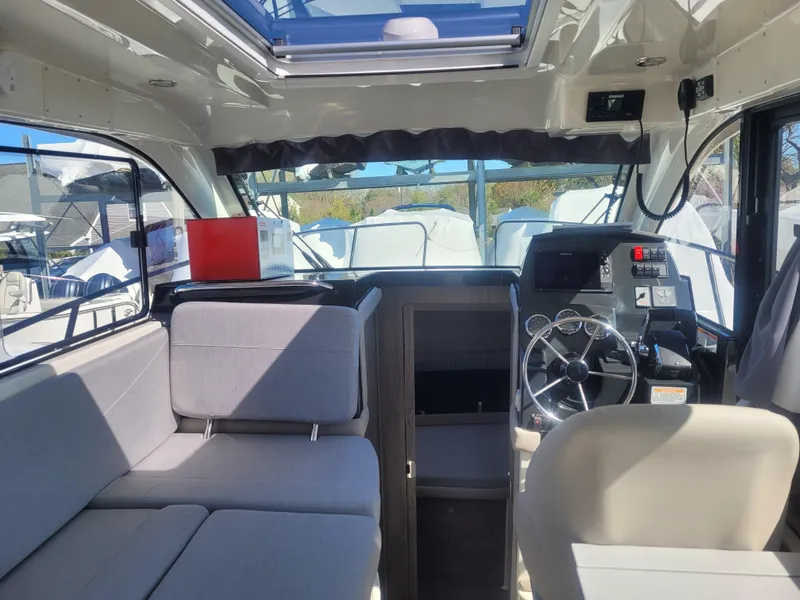 Slide: The Image of Interior of 2025 Bayliner Trophy T29 Explorer boat with modern seating and steering area. - 7