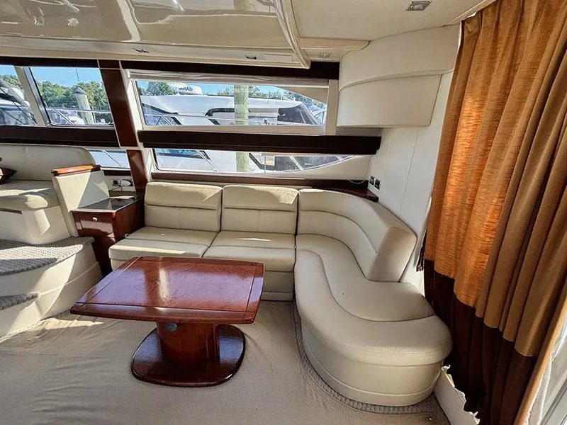 Slide: The Image of Luxurious interior of 2011 Meridian 391 Sedan yacht with cream leather seating and wooden table. - 15