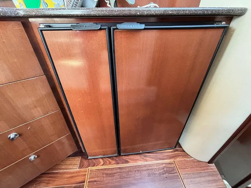 Slide: The Image of Wood-paneled refrigerator in 2011 Meridian 391 Sedan yacht interior. - 20